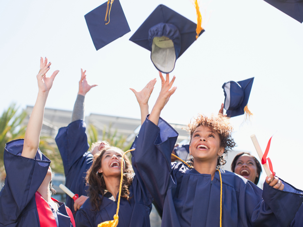 College graduates tossing caps in the air