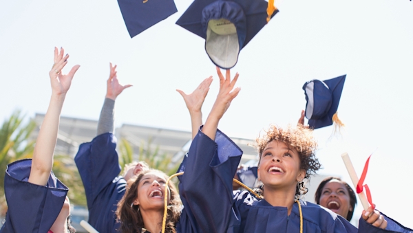 College graduates tossing caps in the air