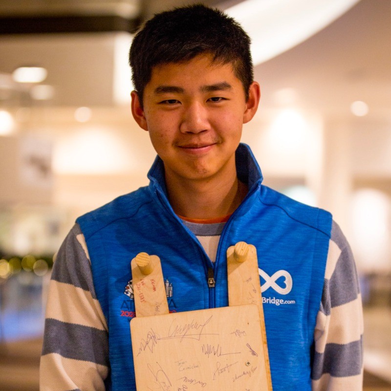 Photo of Nathan Gong with a sideboard for Bridge he made