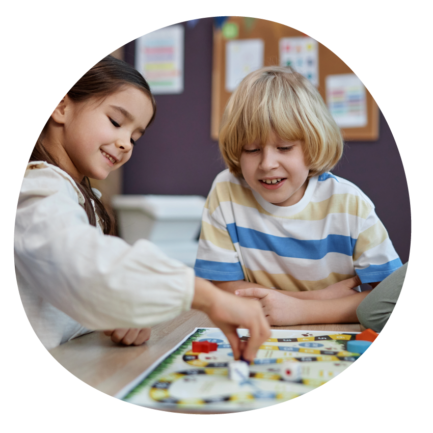 Image: Two children playing snakes and ladders.