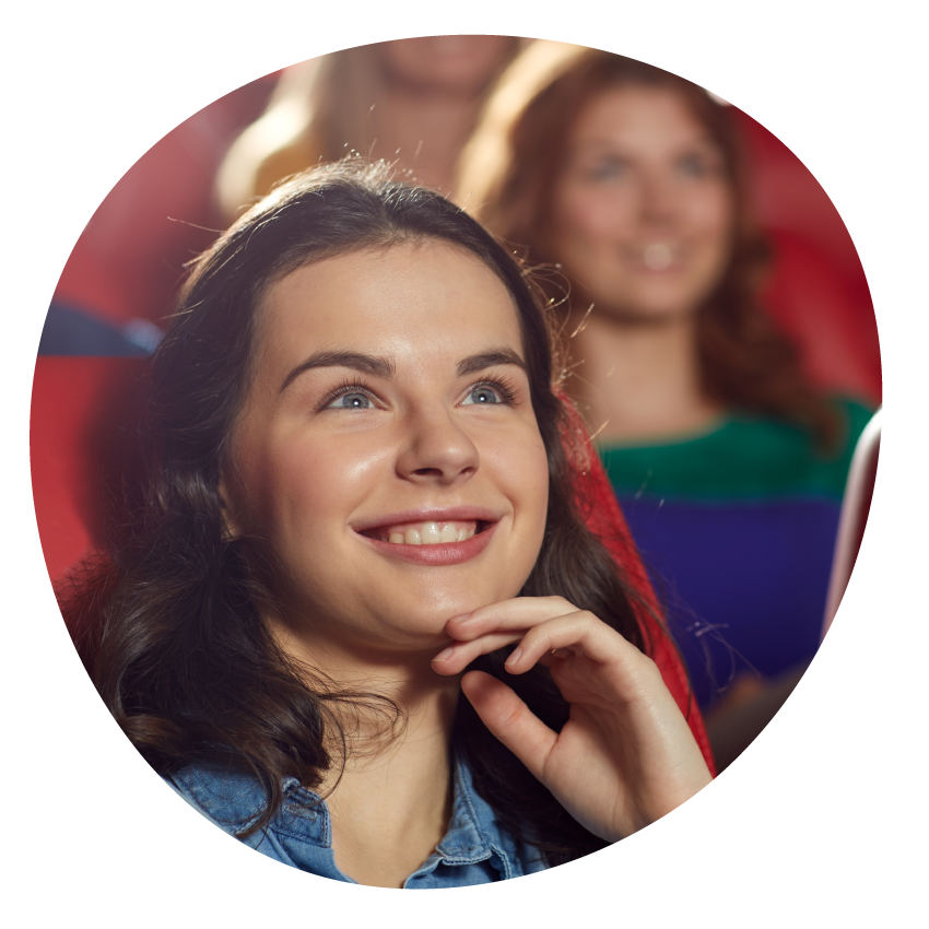 Image: Person holding microphone and smiling. In the background, bright sparkling stars.