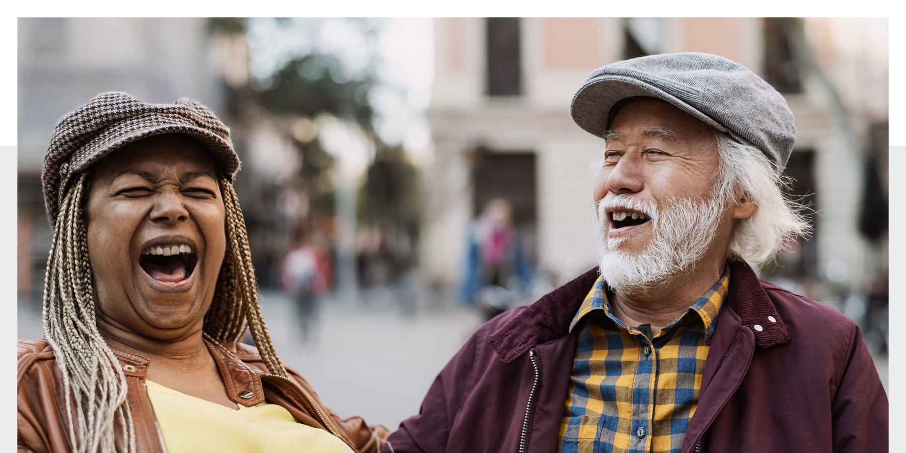 Email Image: Two laughing older people in an outdoor urban setting.