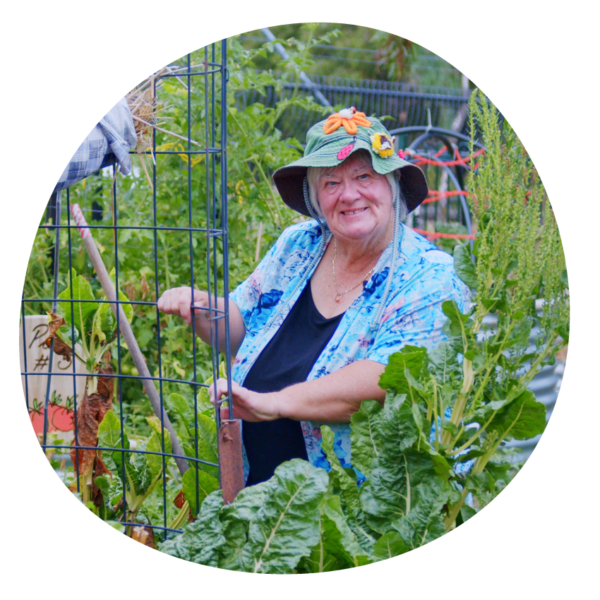 Email Image: A smiling person in a food garden.