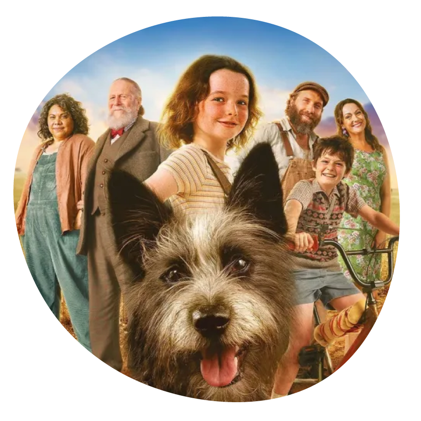 Email Image: Promotional image from the film Runt shows a smiling group of adults and children with a dog in the foreground.