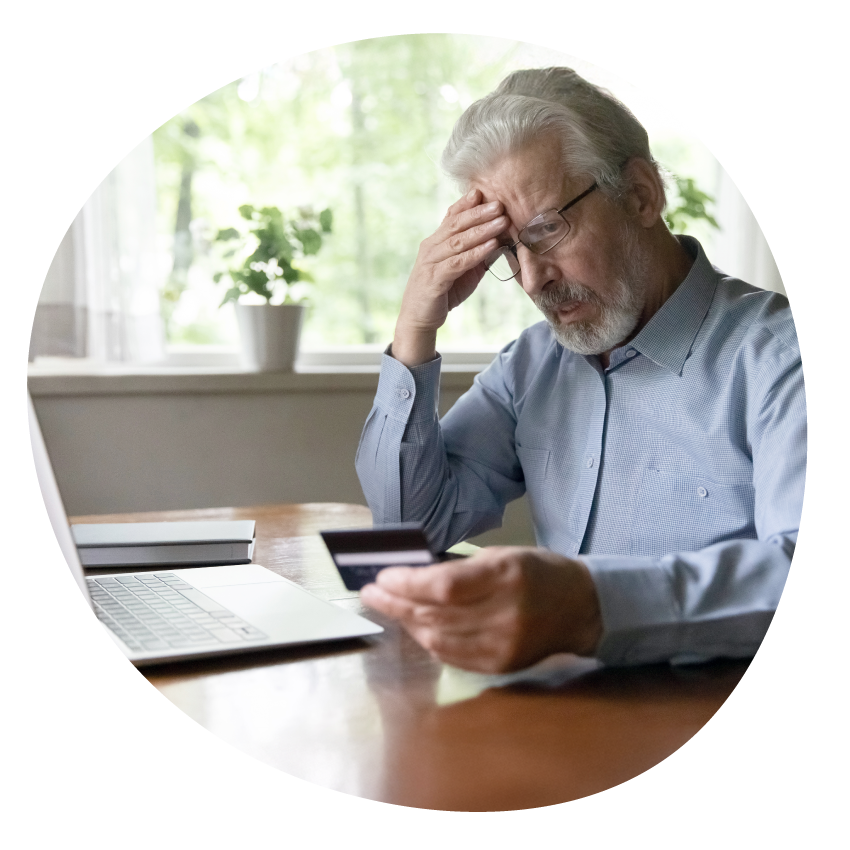 Email Image: A worried older person sits in front of a laptop holding a bank card