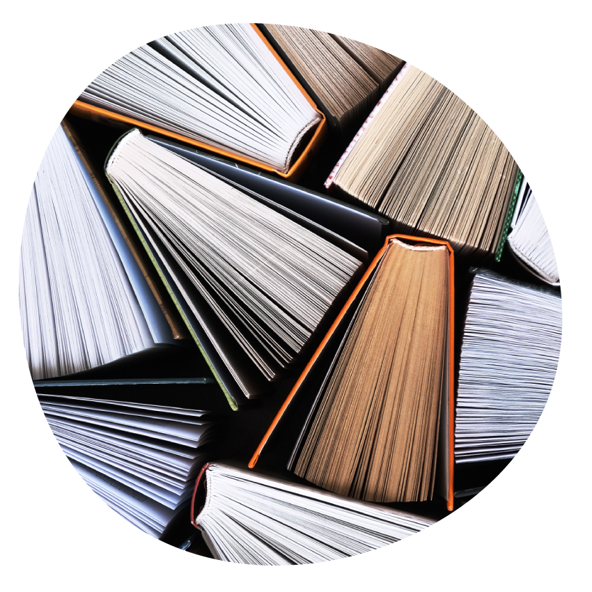 Books standing upright arranged in a cluster so the splayed pages and bottom edges of the covers are visible.