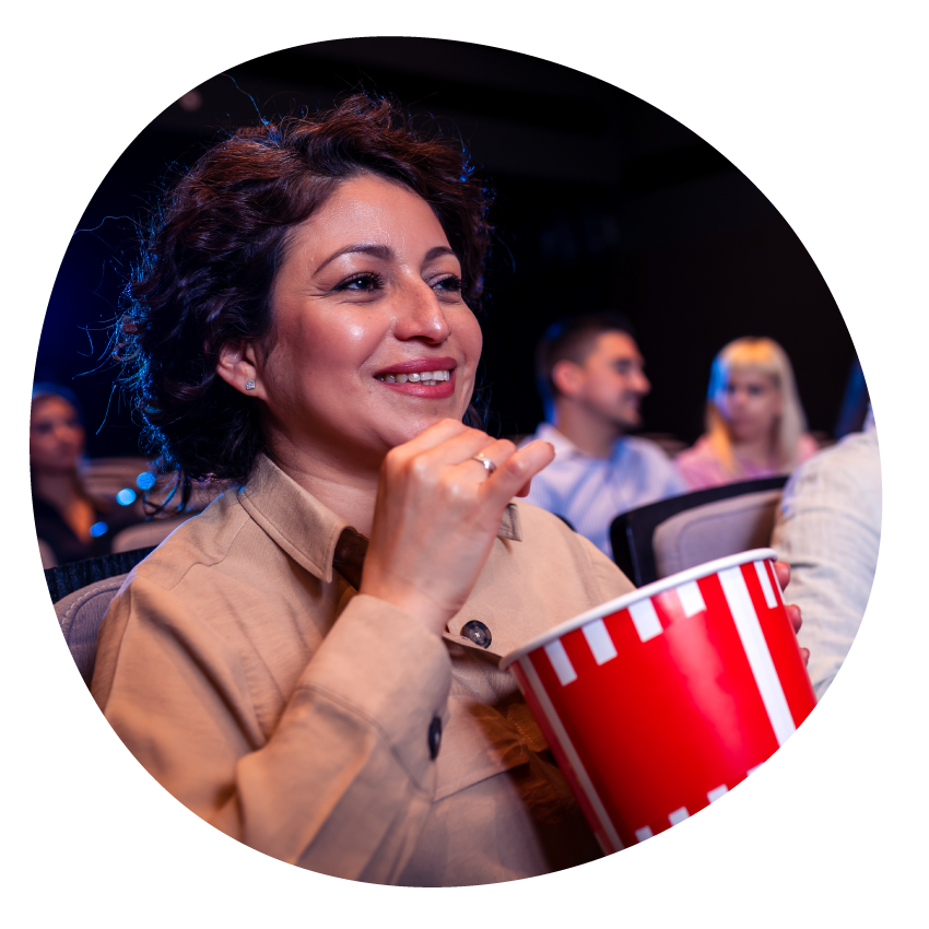Image: An audience seated in rows in a darkened room.
