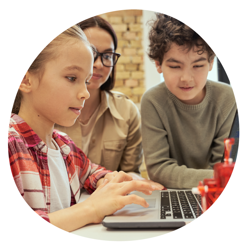  Two children and an adult look at a laptop together.