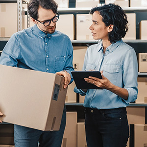 People talking holding package and tablet