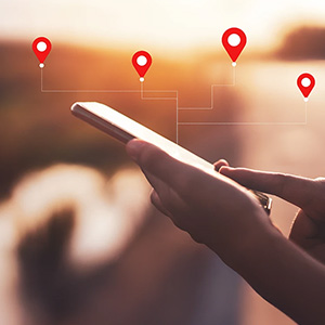 Person using phones with lines going to location markers