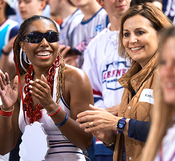 Kendall Featherstone ('26) cheers alongside President Katia Passerini at Kraziness in the Kennel.
