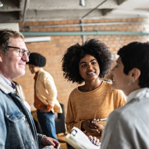 People standing talking in a large room