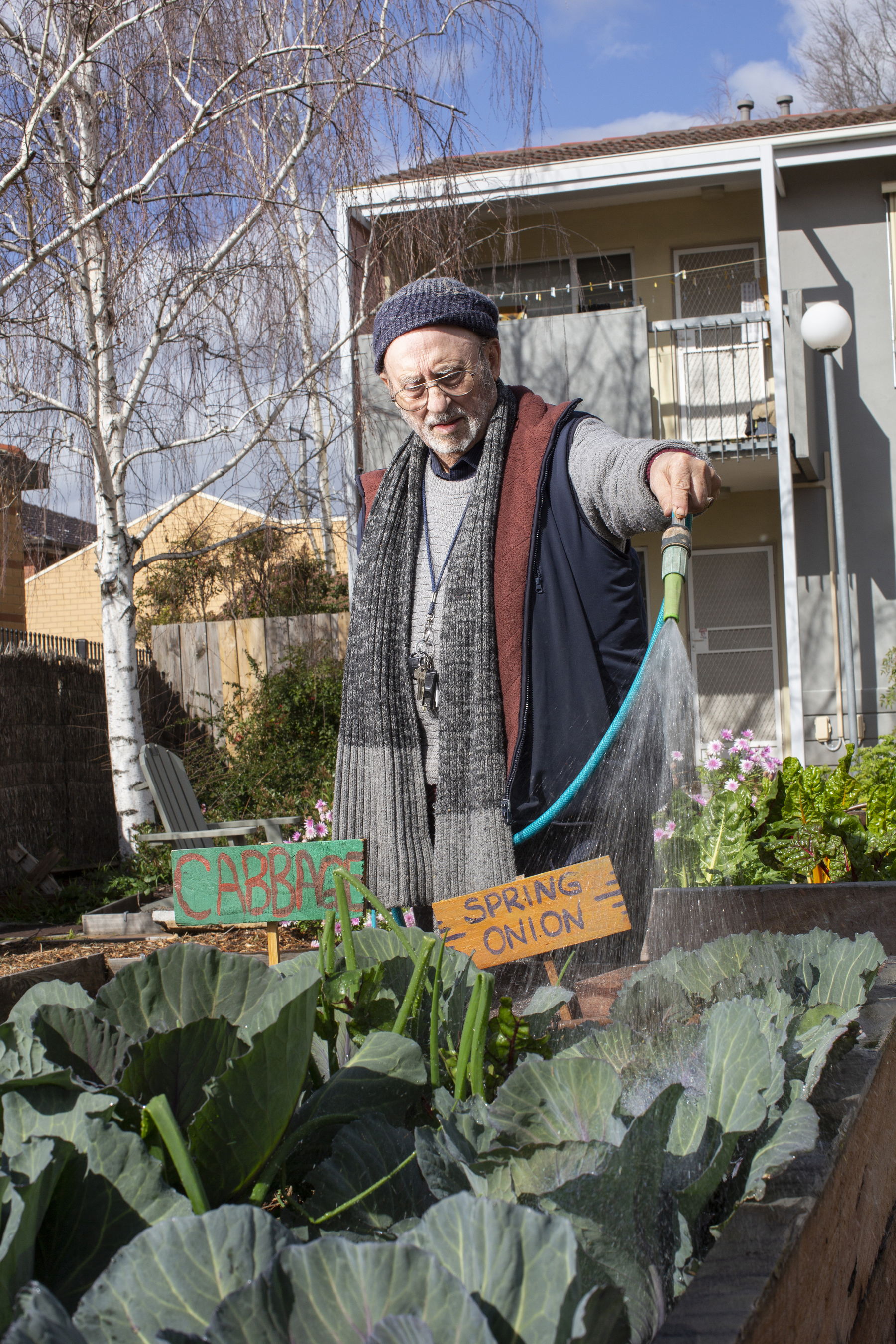 Man watering his garden with a hose