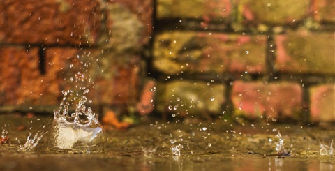 Water droplets splashing on a pavement