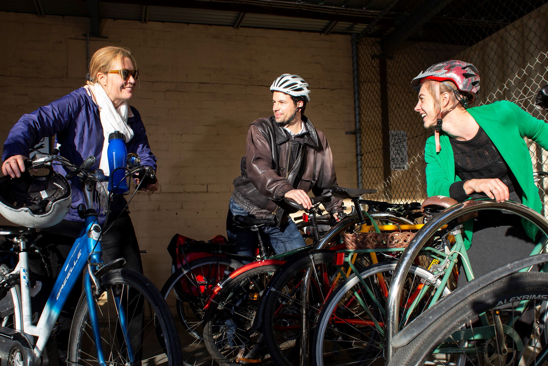 Three colleagues arrive at work on their bikes