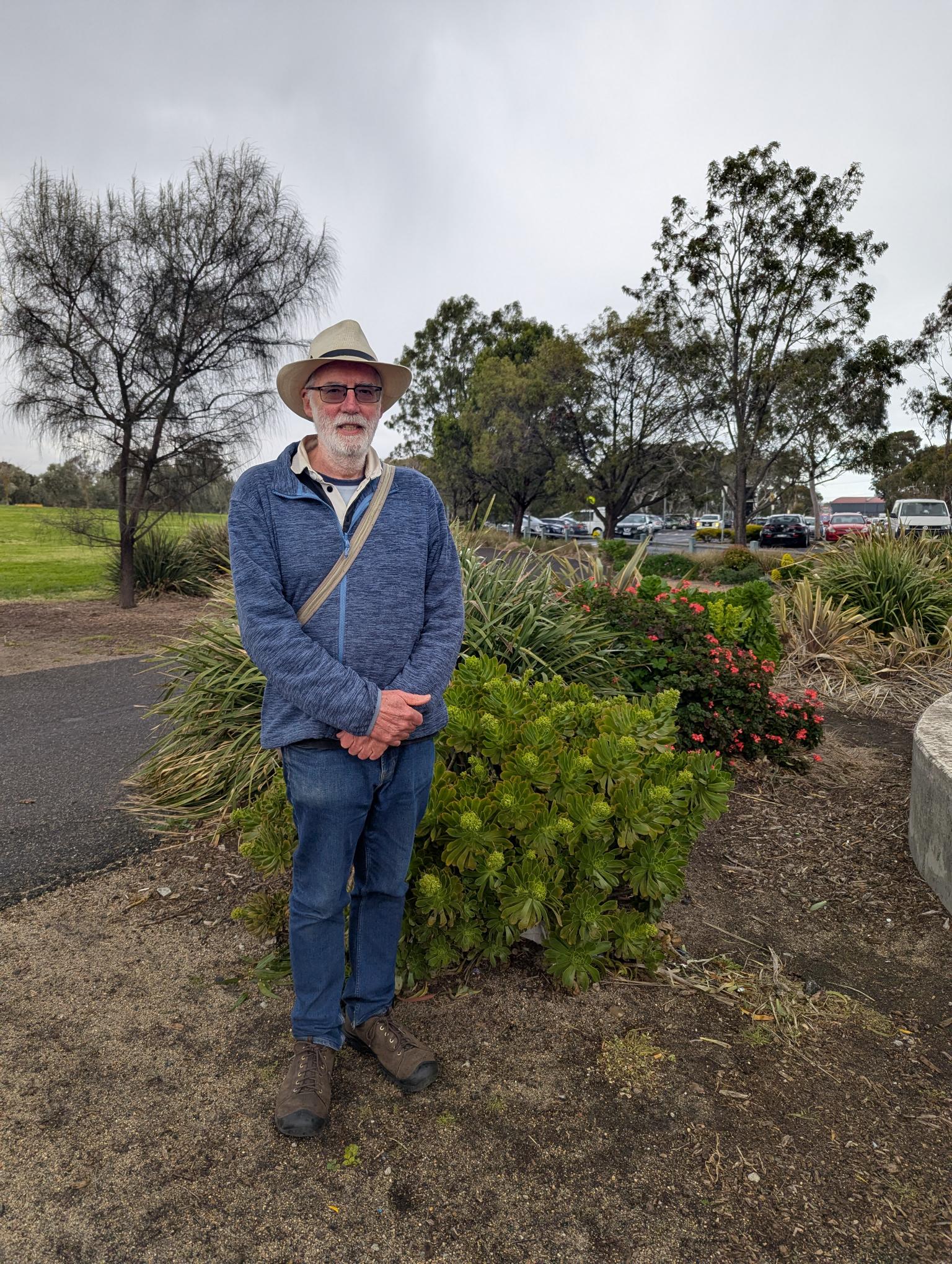 A man standing outside his house near a 