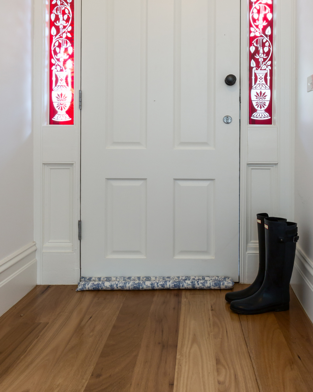 Front door with a door snake underneath to block out drafts