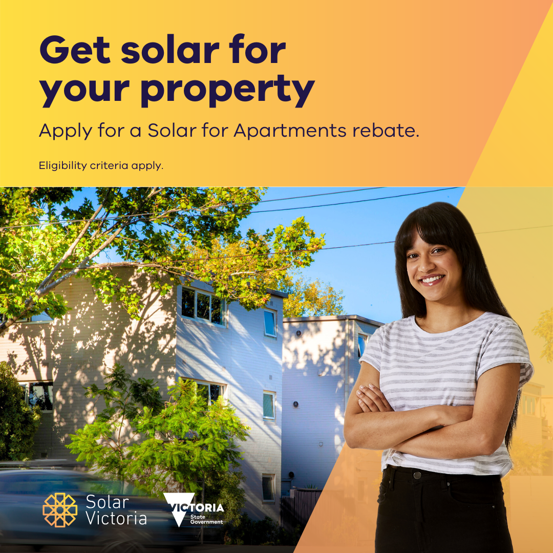 Woman standing out the front of an apartment block with the words Get solar for your property - apply for a solar for apartments rebate.