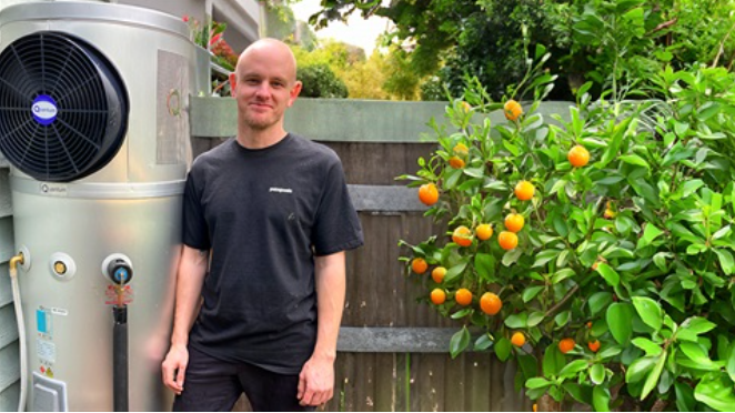 person standing next to an electric hot water service