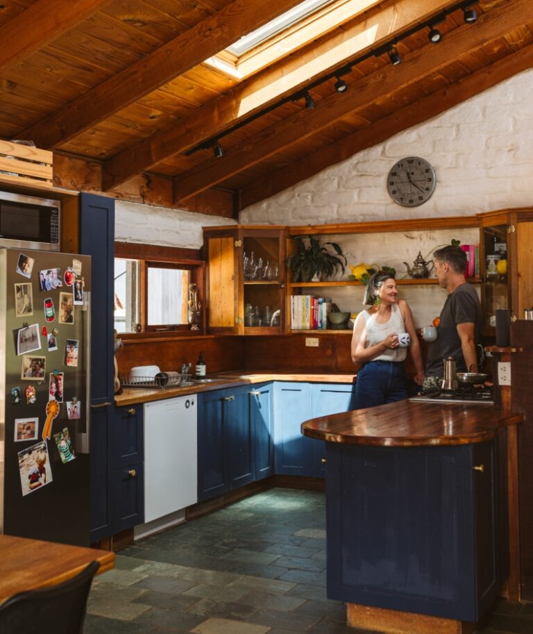 People having a cup of tea standing in their kitchen