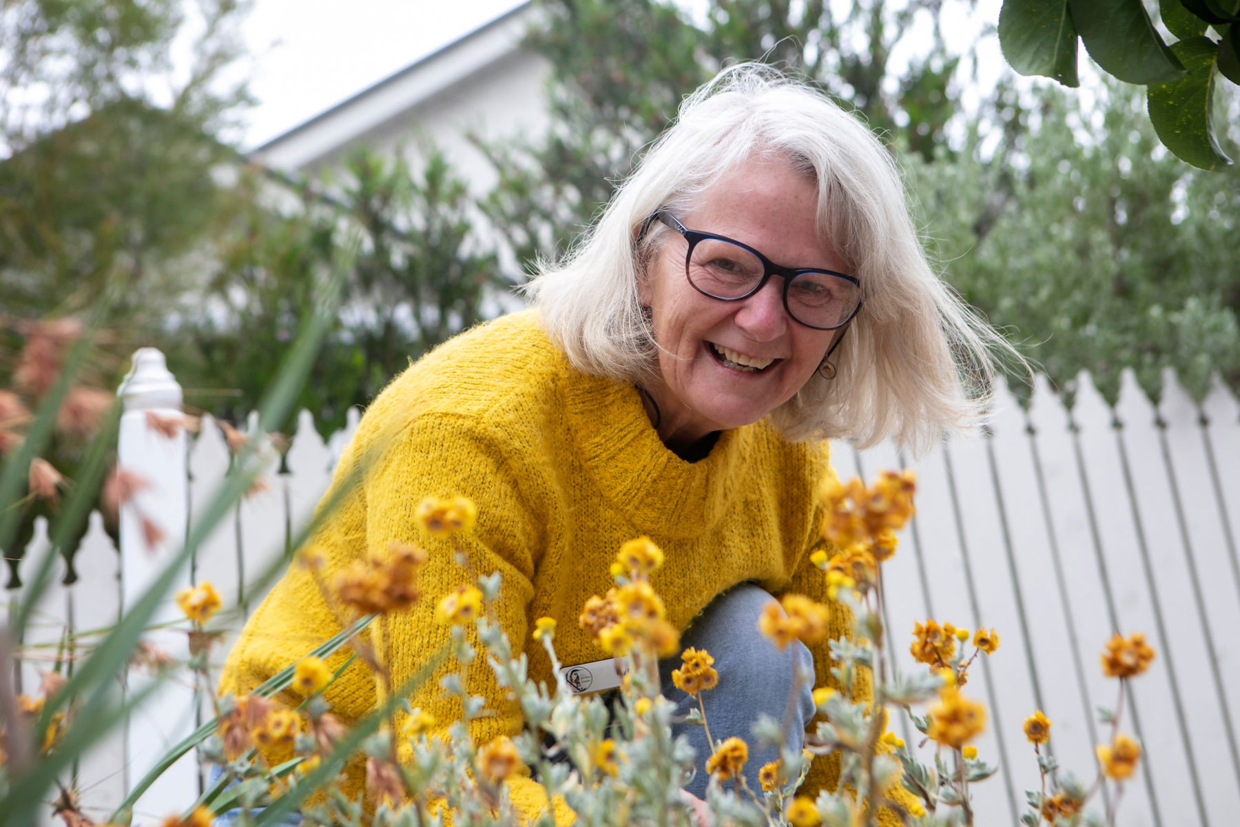 A garden guide volunteer smiles at the camera