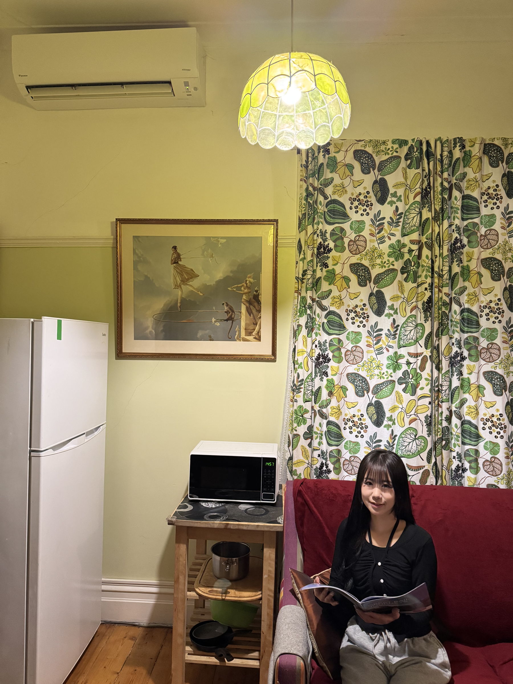 person sitting on their couch under split system