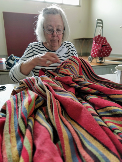 One of our great volunteer fixers, Elizabeth pictured at work in DRC #18 fixing a ripped hammock