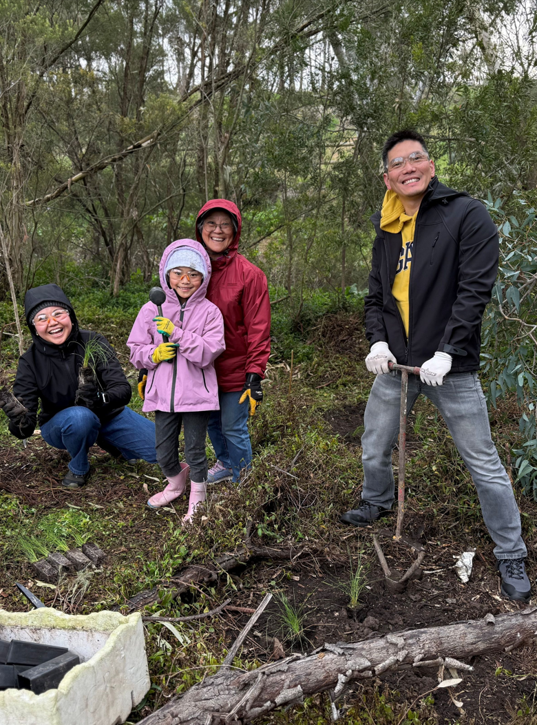 Photo of family participating in a tree planting activity